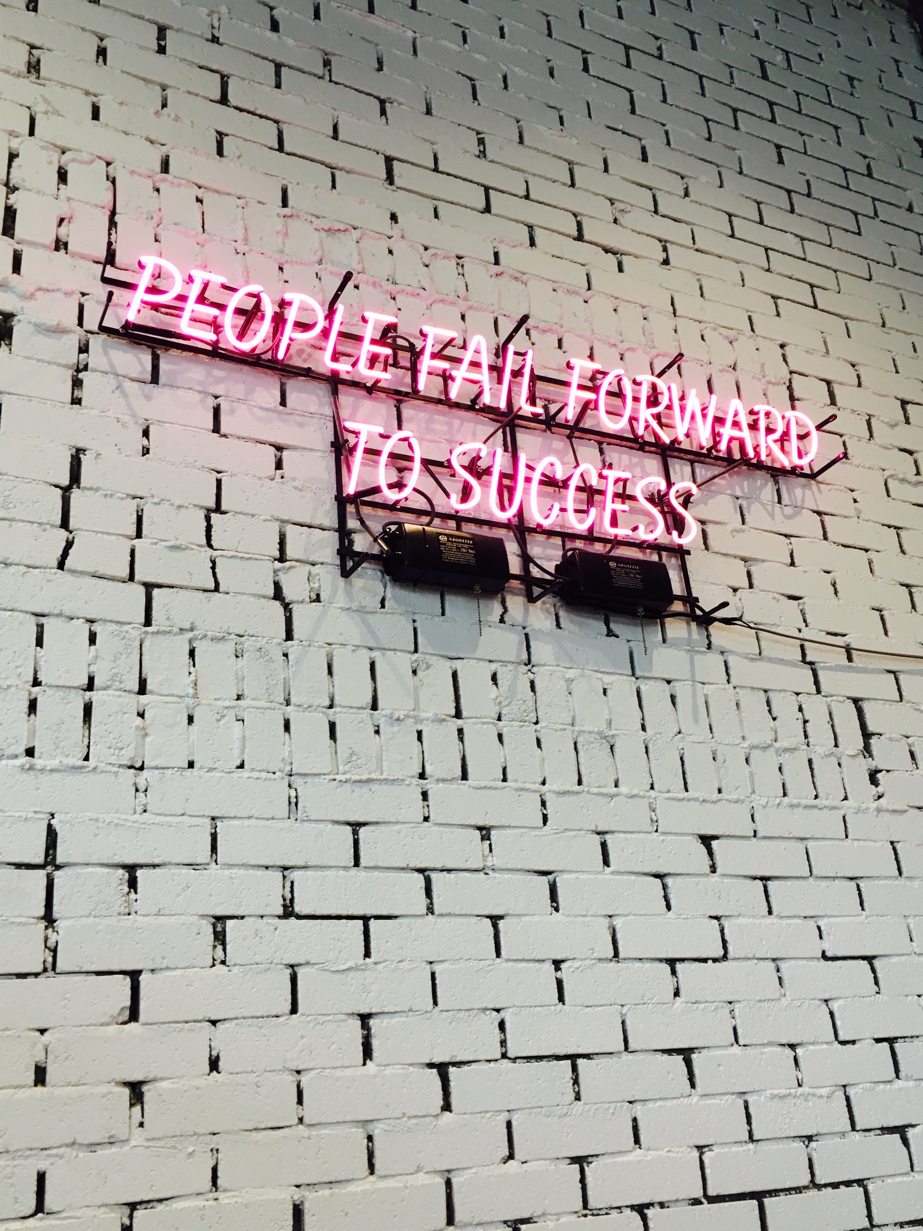 A neon sign with encouraging words about failure